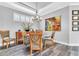 Elegant dining room with a glass table, modern chandelier, and hardwood floors at 20025 Callisto Hill Pl, Tampa, FL 33647