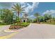 A picturesque community entrance featuring lush tropical landscaping and decorative signage at 20025 Callisto Hill Pl, Tampa, FL 33647