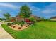 Charming single Gathering home exterior with beautifully landscaped front yard and three-car garage at 20025 Callisto Hill Pl, Tampa, FL 33647