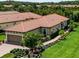 Charming home featuring a clay tile roof, manicured lawn and elegant landscaping at 20025 Callisto Hill Pl, Tampa, FL 33647