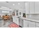 Bright, all white kitchen with island seating, stainless steel appliances and dining area at 20025 Callisto Hill Pl, Tampa, FL 33647