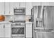 Stainless steel appliances, including a gas range and refrigerator, complement this white kitchen at 20025 Callisto Hill Pl, Tampa, FL 33647