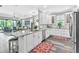 Bright, open kitchen boasts white cabinets, granite counters, stainless appliances, and access to the screened lanai at 20025 Callisto Hill Pl, Tampa, FL 33647