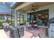 Covered lanai with outdoor seating and grilling area, perfect for entertaining at 20025 Callisto Hill Pl, Tampa, FL 33647