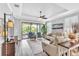 Comfortable living room with stylish furniture, a ceiling fan, and a sliding glass door at 20025 Callisto Hill Pl, Tampa, FL 33647