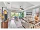 Comfortable living room with stylish furniture, a ceiling fan, and a sliding glass door at 20025 Callisto Hill Pl, Tampa, FL 33647