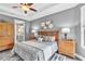 Relaxing main bedroom with a tray ceiling is decorated in neutral colors and natural wood furniture at 20025 Callisto Hill Pl, Tampa, FL 33647