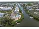 Aerial view of waterfront property with a pool along the waterway and multiple boat slips at 204 Haven Beach Ct, Indian Rocks Beach, FL 33785