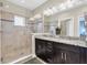 Modern bathroom featuring a glass-enclosed shower and dual sink vanity with granite countertop at 204 Haven Beach Ct, Indian Rocks Beach, FL 33785