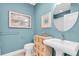 Charming bathroom featuring a pedestal sink and unique wall art at 204 Haven Beach Ct, Indian Rocks Beach, FL 33785
