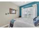 Charming bedroom featuring coastal decor, natural light from shuttered windows, and a serene, inviting ambiance at 204 Haven Beach Ct, Indian Rocks Beach, FL 33785