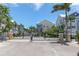 Gated community entrance featuring tropical landscaping and well-maintained surroundings under a bright blue sky at 204 Haven Beach Ct, Indian Rocks Beach, FL 33785