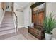 A welcoming entryway features wood floors, a staircase, and a convenient hall tree with bench seating at 204 Haven Beach Ct, Indian Rocks Beach, FL 33785