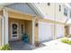 Inviting townhome entrance with a charming blue seating area and well-maintained landscaping, unit #204 at 204 Haven Beach Ct, Indian Rocks Beach, FL 33785