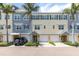 Charming townhomes with colorful facades, garages, and lush landscaping create an inviting curb appeal at 204 Haven Beach Ct, Indian Rocks Beach, FL 33785