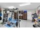 Well-organized garage featuring a home gym area, workspace, tool storage, and epoxy flooring at 204 Haven Beach Ct, Indian Rocks Beach, FL 33785