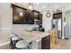 Modern kitchen with granite countertops, stainless steel appliances, and breakfast bar seating at 204 Haven Beach Ct, Indian Rocks Beach, FL 33785