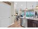Open concept kitchen with stainless steel appliances and views of the living room and outdoor balcony at 204 Haven Beach Ct, Indian Rocks Beach, FL 33785