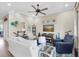 Comfortable living room with an elegant staircase, stylish furnishings, and neutral tones at 204 Haven Beach Ct, Indian Rocks Beach, FL 33785