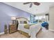 Comfortable main bedroom with calm blue walls, a ceiling fan, and a large window for natural light at 204 Haven Beach Ct, Indian Rocks Beach, FL 33785