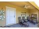 Relaxing covered patio featuring comfortable seating, nautical-themed decor, and a ceiling fan at 204 Haven Beach Ct, Indian Rocks Beach, FL 33785