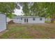 Backyard featuring a brick design, a shed, a white fence, and mature trees for shade at 215 Claire Dr, Seffner, FL 33584