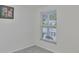 The bedroom has gray carpet and a window for natural light at 215 Claire Dr, Seffner, FL 33584