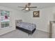 Cozy bedroom with ceiling fan, window and stylish comforter at 215 Claire Dr, Seffner, FL 33584