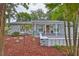 Charming single-story home featuring a brick facade, a cozy porch, and meticulously landscaped front yard at 215 Claire Dr, Seffner, FL 33584