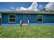 The backyard shows access to the back door with grass at 2307 N 47Th St, Tampa, FL 33605