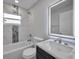 Modern bathroom features illuminated mirror, updated fixtures and combo tub/shower at 2307 N 47Th St, Tampa, FL 33605