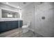 Modern bathroom featuring tiled shower, mosaic tile floor, dual vanities, and recessed lighting at 2307 N 47Th St, Tampa, FL 33605