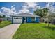 Charming single-story home with a well-manicured lawn and driveway at 2307 N 47Th St, Tampa, FL 33605