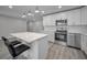 Modern kitchen with white cabinets, quartz island and pendant lights at 2307 N 47Th St, Tampa, FL 33605