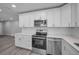 Bright kitchen featuring stainless appliances, white subway tile, and white countertops at 2307 N 47Th St, Tampa, FL 33605