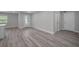 Open living room with wood-look floors, neutral paint, and lots of natural light at 2307 N 47Th St, Tampa, FL 33605