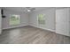 Main bedroom with ceiling fan, hard surface floors, and natural light from the windows at 2307 N 47Th St, Tampa, FL 33605