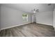 This roomy main bedroom is painted in gray with gray flooring, and features a ceiling fan at 2307 N 47Th St, Tampa, FL 33605