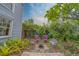 Charming backyard featuring a fire pit surrounded by chairs and lush greenery at 2412 Burlington N Ave, St Petersburg, FL 33713