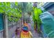 A kayak is tucked away in lush tropical landscaping, with a wooden fence on the left at 2412 Burlington N Ave, St Petersburg, FL 33713