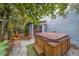 Private backyard oasis featuring a hot tub, lush greenery, and space for relaxation at 2412 Burlington N Ave, St Petersburg, FL 33713