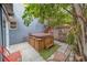 Backyard patio featuring a hot tub in a fenced-in area with tropical foliage at 2412 Burlington N Ave, St Petersburg, FL 33713