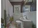 Charming bathroom featuring wainscoting, sleek sink, and a modern window at 2412 Burlington N Ave, St Petersburg, FL 33713