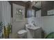 Charming bathroom featuring wainscoting, sleek sink, and a modern window at 2412 Burlington N Ave, St Petersburg, FL 33713