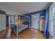 Bright bedroom with hardwood floors, a four-poster bed, and natural light streaming through the windows at 2412 Burlington N Ave, St Petersburg, FL 33713