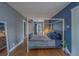 Bright bedroom with hardwood floors, a four-poster bed, and natural light streaming through the windows at 2412 Burlington N Ave, St Petersburg, FL 33713