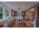 Open concept dining area with natural light, views to the kitchen and front door, and plum-colored walls at 2412 Burlington N Ave, St Petersburg, FL 33713