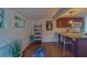 Kitchen area with plum cabinets, granite countertops, bar seating, and an adjacent flex space at 2412 Burlington N Ave, St Petersburg, FL 33713
