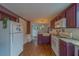 Spacious kitchen featuring plum cabinets, granite countertops, and views to the dining area and backyard at 2412 Burlington N Ave, St Petersburg, FL 33713