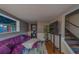 Cozy living room with a plush sofa, mounted TV, and easy access to stairs at 2412 Burlington N Ave, St Petersburg, FL 33713